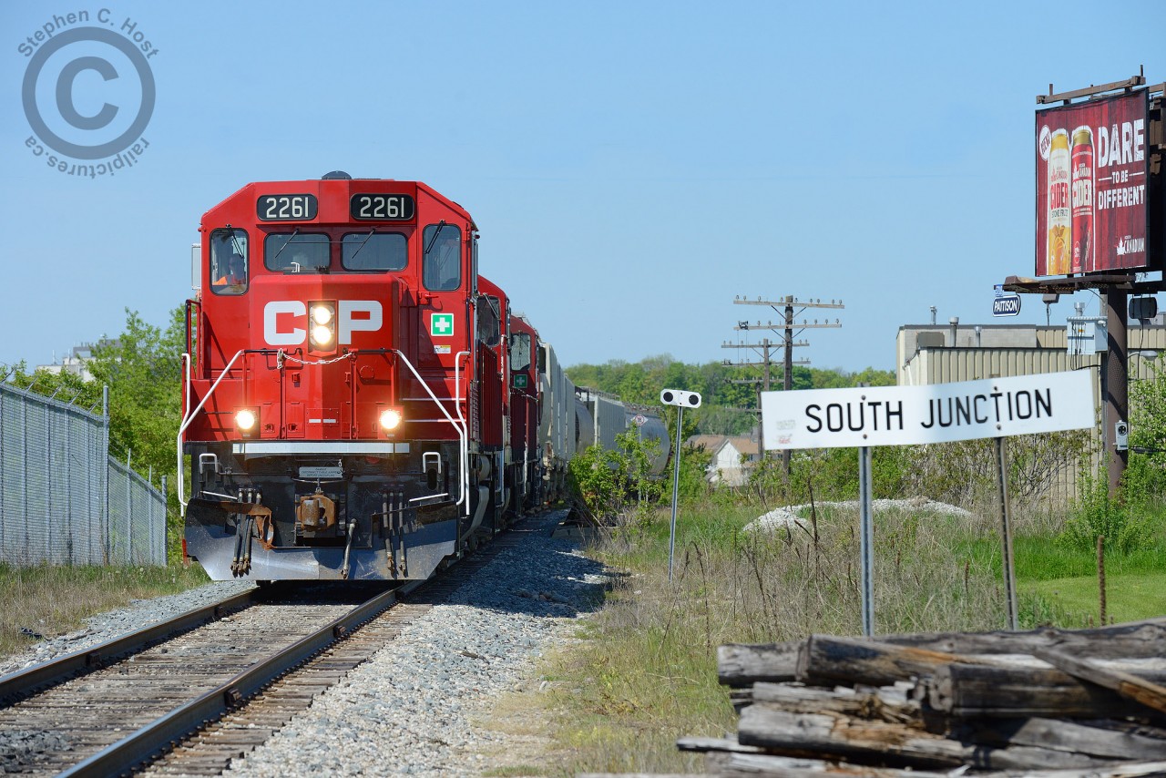 South Junction denotes the northward mileboard to the end of the CPR Waterloo subdivision, formerly known as the Grand River Railway. TG21 is southward bound to Hagey after lifting some cars at the GEXR/CN interchange a mile north of here as the sign denotes. 
A bit of history for those interested - this section of the line was built new in 1960/61 (along with new Codeline) to re-route the Grand River Railway to meet the CN - and run joint section over CN Waterloo sub from South Jct to North Jct (approx location of todays huron park spur and Mill St) where GRR rails resumed to Waterloo. The rebuilding of the GRR made way for construction of Highway 8 in '63. This rebuilding/re-alignment also resulted in the end of electrification of the Grand River Railway and Lake Erie and Northern and the switch to Diesel was made in October '61.For those interested in the lines rich history, pick up a copy of Steel Wheels along the Grand - sold through Credit Valley Railway. The Grand River Railway / Lake Erie and Northern have a rich history not too disimilar to the London and Port Stanley but was a CPR operation largely independent of the rest of the CPR well into the 90's. The last GRR employee retired only a few years ago.