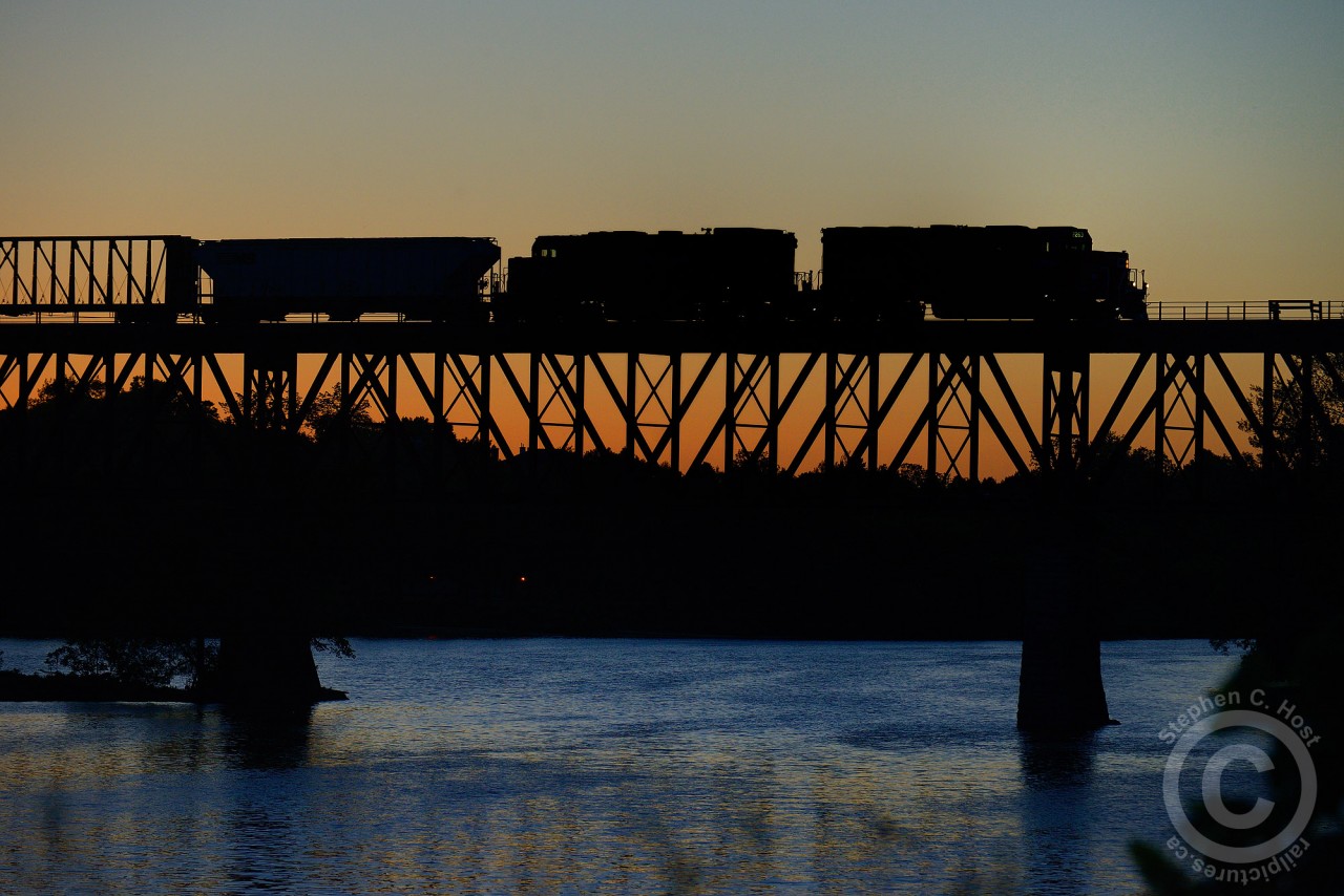 Two generations of EMD power - GP20C-ECO 2263 and GP38-2 3027 form a silhouette against a deep orange sunset at Galt, Ontario. But not a perfect silhouette, as the engineers side numberboards on the eco 2263 are angled enough to properly expose in my frame. Personally, I think it adds to the shot.