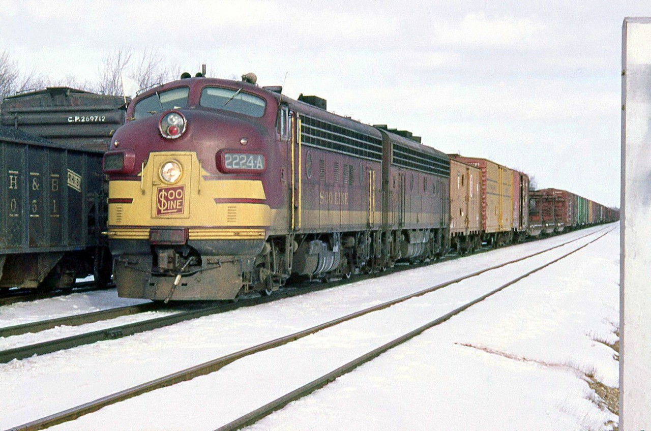 With white extra flags flapping, SOO Line FP7 2224A and a B-unit head west at Guelph Junction with freight in tow, over CP's Galt Subdivision in February of 1964.