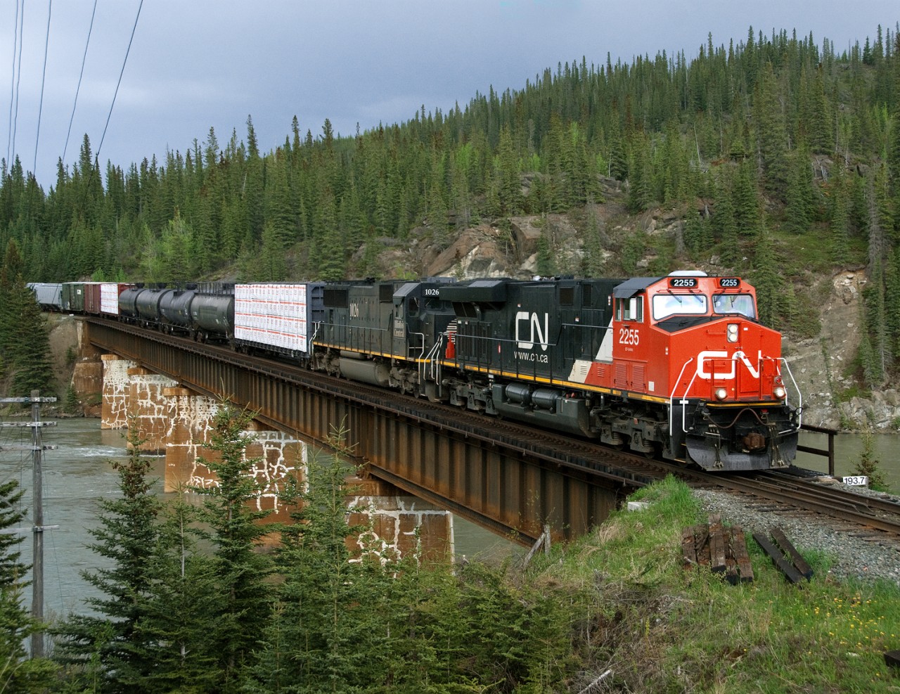 Westbound mixed freight 303 crosses the Athabaska River between Hinton and Jasper Alberta