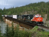 Westbound mixed freight 303 crosses the Athabaska River between Hinton and Jasper Alberta