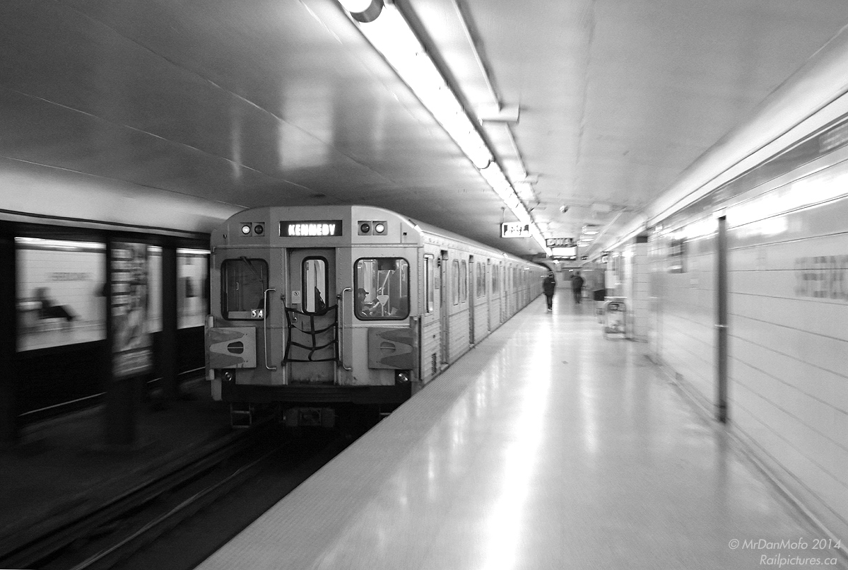 Going, going, gone. With the final TTC H6 run taking place today (Friday June 20th 2014), it's only fitting to dig out a few shots of the ol' tin-cans in action. Employing some "zoom-panning" for this shot, H6 car 5814 trails a westbound train zipping out of Sherbourne subway station, bound for the busy Bloor-Yonge stop down the line.  Built in 1985-1989 by Urban Transportation Development Corporation Ltd (in a partnership with Hawker Siddeley Canada known as "Can Car Rail") and easily identifiable by their orange doorways and yellow velor seats, the 126 H6 cars were just the next iteration of the Hawker Siddeley "RT-75" subway car design (dating back to the early-mid 60's) and occupied the 5810-5935 number block after the H5 cars. Known as the least-reliable of the fleet due to a few issues, they spent virtually all their lives operating on the Bloor-Danforth subway line out of Greenwood Yard. An option for more new Bombardier Toronto Rocket cars was exercised to replace the aging H6's. Initially a deal was signed to sell a group of 255 H5 and H6 cars to Nigeria for a new rail transit system in Lagos, but the deal was reduced to a smaller group of H5's, with all the other cars bound for local scrapyards.
