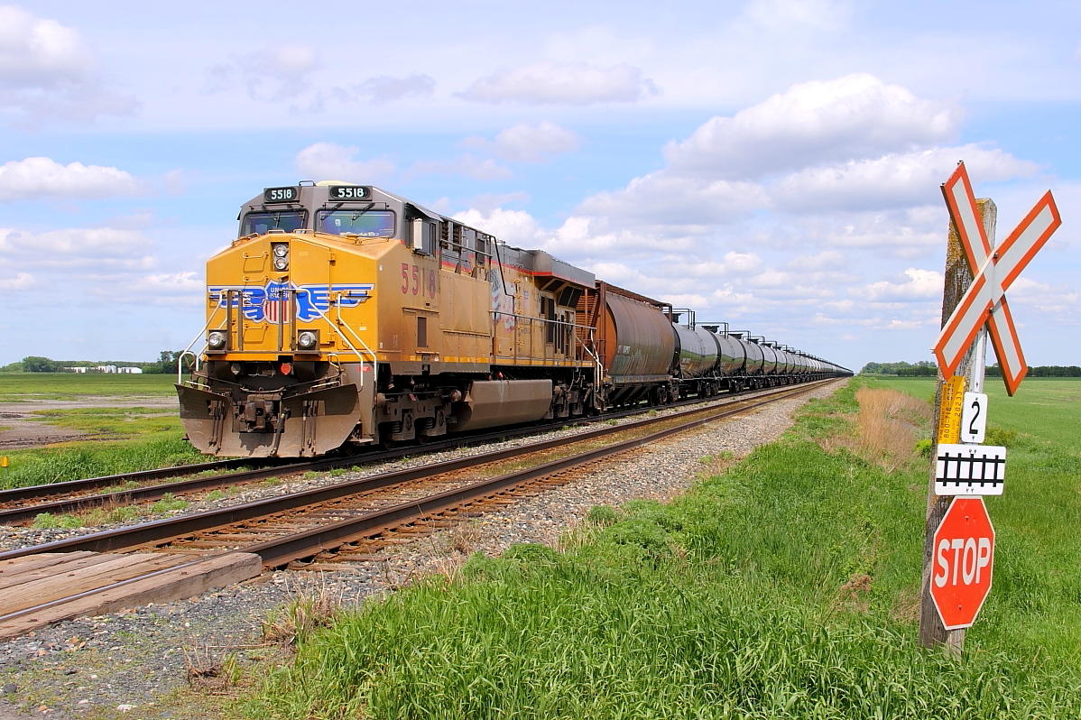 Crude oil empties lead by a leased UP GE wait at High Bluff for a clearance to proceed westward to Portage to head up CP's Minnedosa Sub.