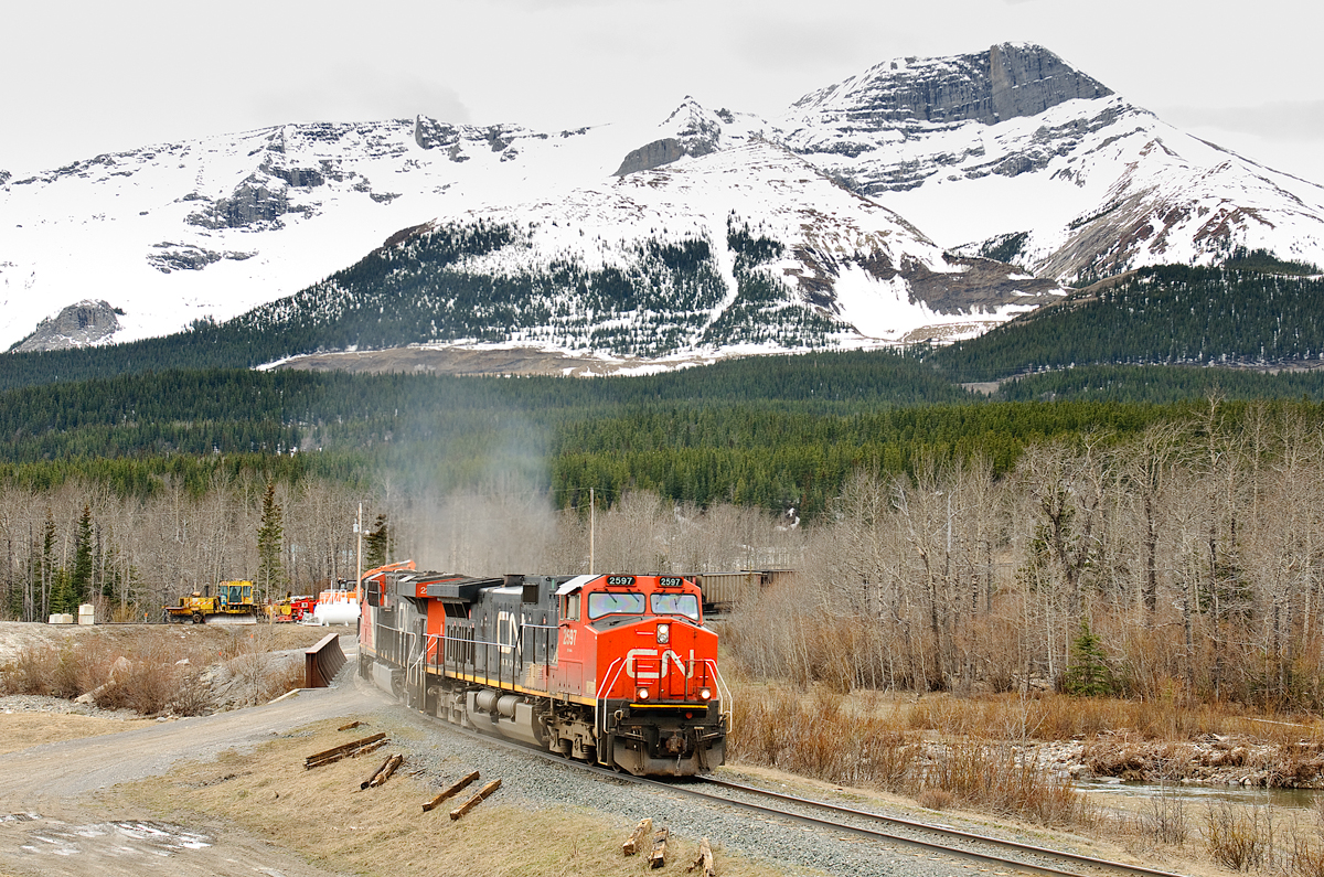 CN C44-9W 2597, CN ES44DC 2316 and CN SD70M-2 8949 "pull" 56 loads of coal off of the steep Luscar Industrial Spur. Due to the severe grade and heavy coal train, brakes are applied at the top of the hill where the coal loadout is located, and the train is pulled down the hill to avoid a runaway. L769 will now venture across CN's 26 mile roller coaster Mountain Park Sub and then onto the Foothills Sub at Parkhill Junction. They'll take their 56 cars to the siding at Embarras, and then return light power to the yard at Leyland (half a mile behihd me) to get the other half of their train and continue loading. Once loaded, they'll run around their train and pull the other 56 loads over to Embarras, double their train together and make a run to the mainline (Edson Sub) at Holloway. This normally takes 2 crews, sometimes 3 if things don't go according to plan!