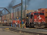 CP 9379 & CEFX 1034 Stop for some fuel and a new crew before heading west to Calgary. Plumes of smoke are the departing eastbound inter modal headed for the US.