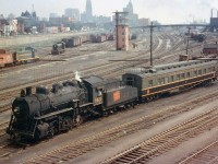 Steam era action at Bathurst Street: Canadian National 0-8-0 8421 switches a heavyweight business car around the Spadina Coachyard (off to the right) at Bathurst Street bridge. New GMD SW1200RS and ALCO/MLW S-series diesel switchers work the freight-only Bathurst Street yards to the left. The CN Spadina Roundhouses' coaling tower is visible to the upper right, where dozens of steam and diesel power were maintained for service out of downtown Toronto. Also of note is the relatively new looking brick yard tower (identical ones were at Mimico and Don Yard, all demolished today). The Toronto skyline 50+ years ago looks much different than it does today, with the tallest building being the Canadian Commerce Bank Building (which was also the tallest building in the British Commonwealth). It held this distinction from 1931 to 1962, and was 69 feet taller than the Canadian Pacific's Royal York Hotel, also visible here above the yard tower. <br><br> CNR (or GTW) 8421 shown here was one of six P5j 0-8-0 switch engines built by Brooks, purchased from original owner Buffalo Creek Railroad in 1947 and assigned Grand Trunk 8400-series numbers. "GTW" 8421 (however it's shown here sporting CN lettering on the tender's wafer logo) is former BCK 27, and operated in GTW/CN service with its former owner's number and lettering after purchase until becoming 8421. Most photos show these steamers around downtown Toronto, switching the freight and passenger yards in the area. All were retired by the end of the steam era in Canada, and scrapped.