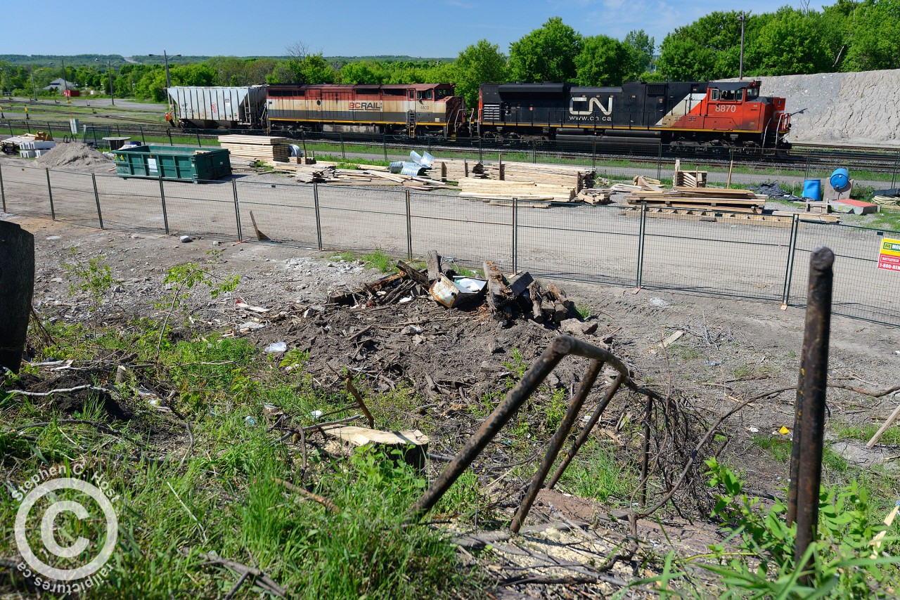 At Stuart St - a very recent brush cutting has revealed an old staircase which once led passengers to the station platform of the approx 1875-1930 Great Western Railway built station. Located just to the left of the staircase, this station was built by the Great Western and removed approx 1930 when the new James St. North building was constructed. This would have been the second station built at Hamilton.For a photo depicting the old station, see this link: here
A photo of the first Great Western Railway station - estmiated more to the left but closer to the mainline (was in the middle of the yard, essentially near the former CN/SOR shop building) can be found on Ray's Old Time Trains site here with plenty more detail for those interested in history
It is my belief all of this is now gone and will soon be paved over to make way for the James St. North station parking lot.