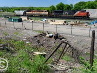 At Stuart St - a recent brush cutting - removing decades of growth -  revealed an old staircase which once led passengers to the station platform of the approx 1875-1930 Great Western Railway built station. Located just to the left of the staircase and built by the Great Western Railway, it was removed approx 1930 when the new James St. North building was constructed. The GWR station would have been the second station built at Hamilton, the first built approx 1855.<br><br>For a photo depicting the second station, see this link: <a href=http://transpressnz.blogspot.ca/2012/09/hamilton-stations-ontario-canada.html>here</a><br><br>A photo of the first Great Western Railway station - estmiated more to the left but closer to the mainline (was in the middle of the yard, essentially near the former CN/SOR shop building) can be found on Ray's Old Time Trains site <a href=http://trainweb.org/oldtimetrains/GWR/history.htm>here</a> with plenty more detail for those interested in history<br><br> In this scene CN 330 is making a set-off in the yard, and construction crews are busy with James St. North new GO station and Bay St overpass - once all completed - the foreground lands will become the parking lot for James. St. North GO Station. All of this built posthaste due to the Pan-Am Games in 2015.<br><br>For anyone interested in old stations of the Great Western - head to Grimsby where the 1855 wooden station still stands and would have looked very similar to Hamilton - and is likely the oldest Canadian wooden station still in existence and stands as a pottery store beside the VIA stop. 