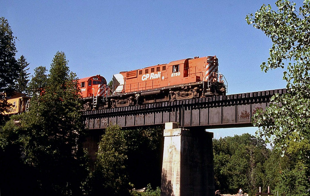 Canadian Pacific RS18 8750 and C424 4214 are in charge of CP's Goderich Wayfreight, heading back south en route to Hamilton. The units are seen crossing the trestle over Bronte Creek in the town of Progreston (south of SNS Flamboro on the Goderich Sub, today part of the CP Hamilton Sub).  [Editor's Note: for a shot of the same spot today (not much has changed!), see Ryan Gaynor's photo here: http://www.railpictures.ca/?attachment_id=10037].