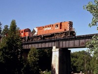 Canadian Pacific RS18 8750 and C424 4214 are in charge of CP's Goderich Wayfreight, heading back south en route to Hamilton. The units are seen crossing the trestle over Bronte Creek in the town of Progreston (south of SNS Flamboro on the Goderich Sub, today part of the CP Hamilton Sub). <br><br> <i>[Editor's Note: for a shot of the same spot today (not much has changed!), see Ryan Gaynor's photo here: <a href="http://www.railpictures.ca/?attachment_id=10037"><b>http://www.railpictures.ca/?attachment_id=10037</b></a>].</i>
