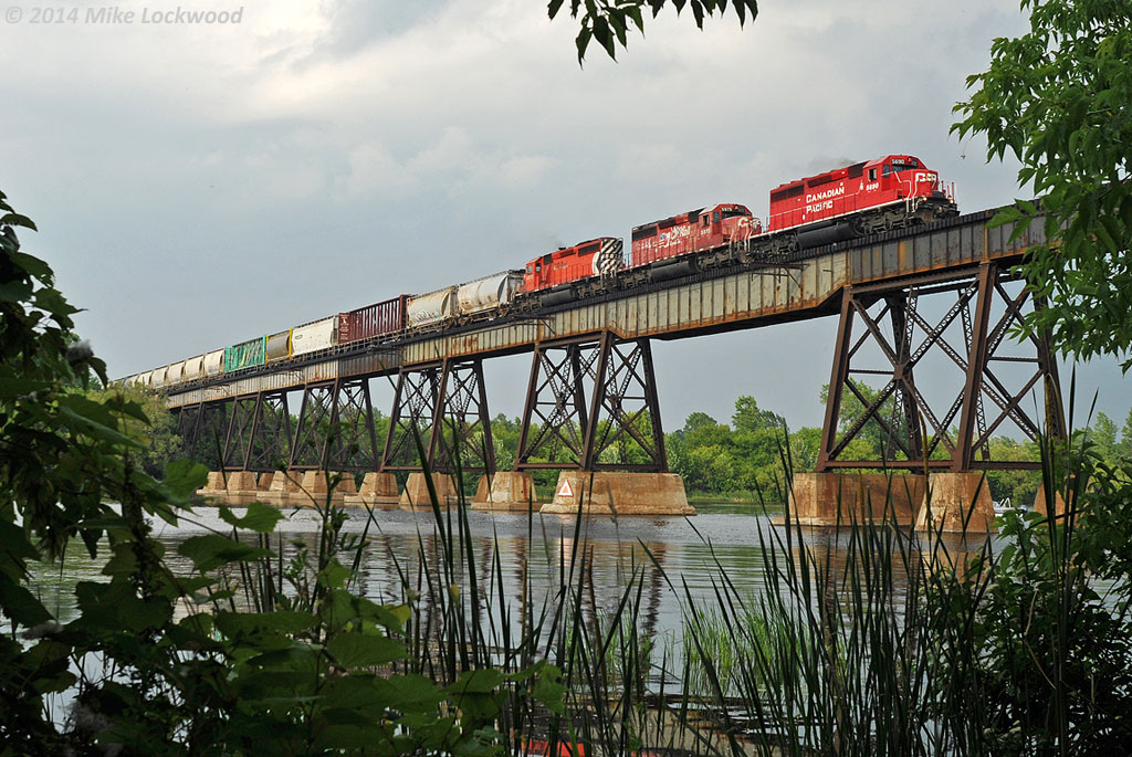Accelerating across the Trent River, CP 5690, 5975, and 5872 hustle 241's 60 car train west at Trenton, Ontario. Often sporting a single GE, the trio of SD40-2's were probably appreciated on this 241, if for no other reason, than their faster pace accelerating from slows, stops, and of course, up hills. 1841hrs.