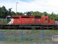 <b>Seen better days</b>. Built in 1979 at General Motors Diesel's London assembly plant, this is what a locomotive looks like after nearly 30 years of hard use. Still wearing her original paint and one of only two units sporting the full-height "Large Multimark" logo at the end, CP SD40-2 5911 hustles an eastbound freight through Streetsville on the way to Toronto Yard, while the photographer tries to dodge construction obstructions from the ongoing platform expansion project.
<br><br>
There's about 3 different shades of faded red on her, with a well-worn coat of dirt and road grime from all across North America built up over the years (regular washings and cleanings are a thing of the past). Oil from the 3000hp 16-645E diesel engine streaks out the bottom of her hood doors, down the frame and fuel tank. Tattered "CP Rail" lettering dating from about 3 corporate identity changes ago still clings to the hood doors, well-scorched by a hot exhaust manifold after countless miles of running full-throttle.
<br><br>
More subtle signs of hard use rivet counters will pick up on include 3 different styles of wheel roller bearings (after unknown many wheel, traction motor and truck changeouts), replacement fan bases still in grey primer, quickie safety white touch ups on the handrail ends, new and additional labels and warning stickers all over, and who knows what else under the hood.