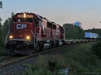 One of my goals of late has been to shoot in less than perfect lighting conditions with the aim of going no higher than ISO250 at 1/500th... so dropping down to F4 and F2 is common on post-sundown shots or on cloudy days. In the former category, the eastbound eXpressway's departure out of Hornby usually has it through my neck of the woods in poor light on long summer days, so it has been a frequent target. The sets of SD's on it lately are a nice touch, too. Here, the soft dusk light reflects off the flanks of CP 6256 and 6249 at the west end of Cherrywood siding, barely into their largely nocturnal run to Montreal. 2043hrs.