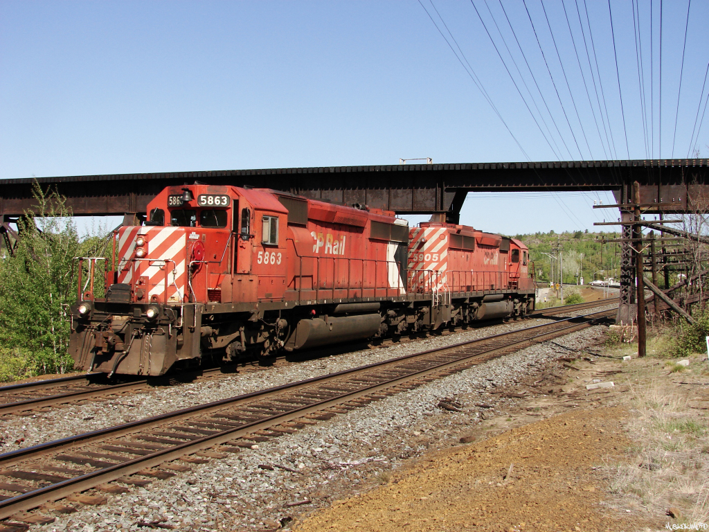 CP U50-16 (Sudbury #2 roadswitcher) with CP 5863 and CP 5905 scoots underneath CN's Sudbury spur heading back to the yard in Sudbury light power. CP 5863 is one of only 2 remaining active units to wear the full multi-mark, with 5863 assigned to Winnipeg yard, and 5911 currently at Alyth but still active as far as I can tell.