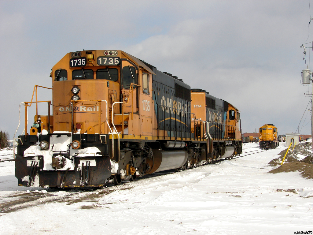 ONR SD40-2's 1735 and 1734 wait on the shop lead as their crew readies some paperwork for the homeward trip as train 414 to Englehart, meanwhile a hostler has come from the shops to cut off GP9 1603 from the tail end of the consist, and is heading for the shops with it.