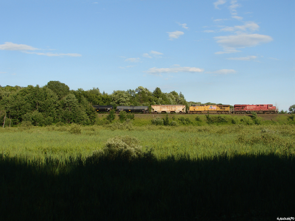 CP 8758 South handles long and heavy loaded crude train 608 approaching MacTier, with help from UP 5318 on the head end, and UP 5525 working on the tail end of 121 cars!