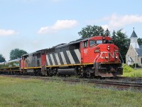 On a sunny day a cloud comes across putting all but 5517's nose in the shade! 5517 and 2440 are pulling an all intermodal east with two Passenger cars in old CN livery-Sanford Fleming and Tawaw.