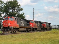 Three GE locos in "elephant formation" 2669,2310,2640 head west on the north track having picked up cars at Paris.