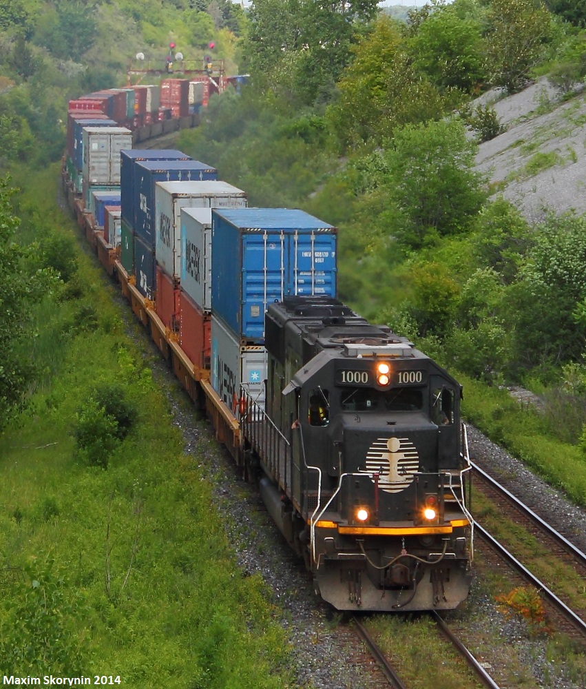 A one of a kind class leader for train 112... IC 1000 leads CN 112 around the corner and almost at its destination at Brampton Intermodal Terminal on its long, several day journey from British Columbia. At the end is CN 2309 shoving, so 1000 isn't doing all the work by itself.