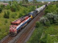 After getting another timely heads up that this rare Canadian National train X371 has cleared Kingston with a stellar lash-up, me and Railpictures.Ca contributor Alex Titu head out to catch it. After a while, it is captured in this scene. Alex Titu can be seen in action on the pedestrian bridge in the background.