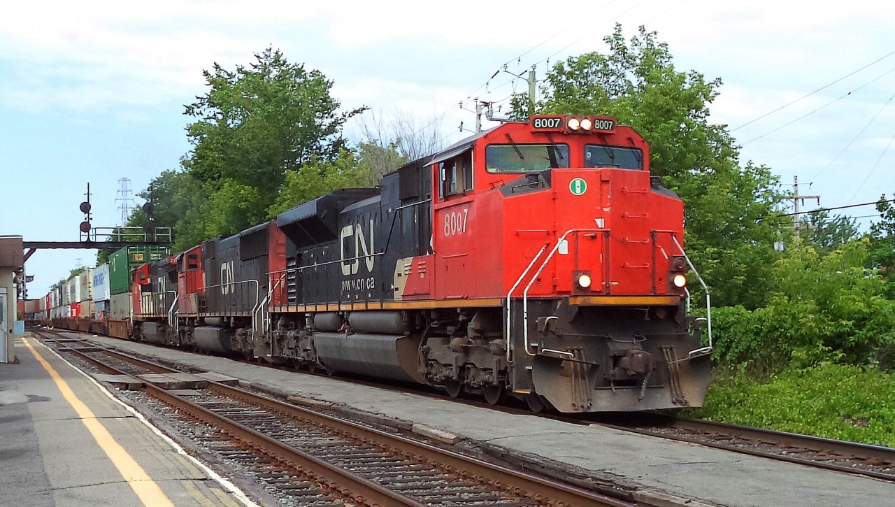 CN-8007 a SD-70m2 leading loco with loco CN-5659 SD-75I -s also CN-2182 C-40-8w pulling a containers convoy going to the Maritimes up to Halifax N.S.CN-8007 logo CN logo almost all gone