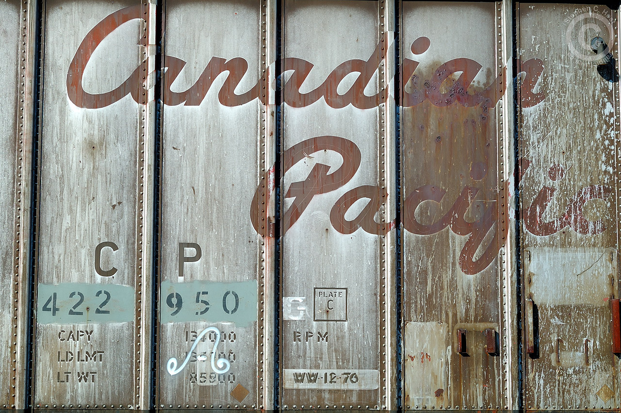 At Galt, a work train in the yard consisting of an eclectic mix of vintage Canadian Pacific OCS work equipment including an old insulated reefer in the Script livery. This photo is a close-up of the detail found showing off the riveted construction of the car.