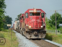 At Ayr Mileboard, 240-24 is pulling slowly out of Wolverton after lifting 30 from the yard. A byproduct of the Hunter Harrison/Bill Ackman era at CP was cancellation of the SD60 rebuild program - allowing us the chance to be shooting images like this in 2014.. if one is lucky enough. For the photographers wondering about the dark background - the edge of cloud/shadow was at the tail end of this train in Wolverton, making for a 'storm light' effect.