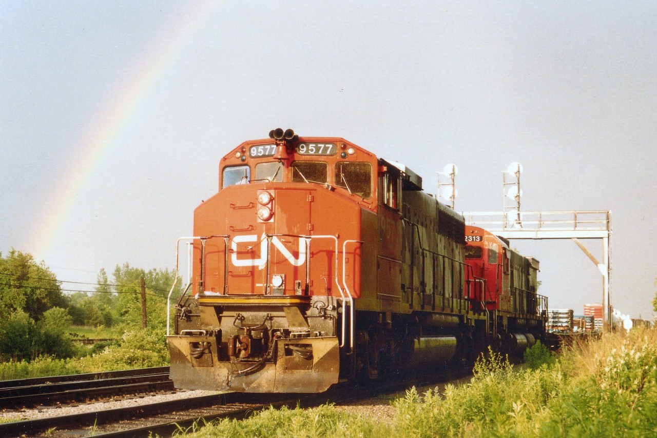 Late day showers resulted in this rare opportunity to catch CN within the confines of a rainbow as the train exits Fort Erie heading for Toronto. Power is CN 9577 and 2313. Lead unit converted to a GP40LH-2 for the Massachusetts Bay Transit Authority by 1997, and the 2313; well, it met the fate of all mainline CN MLWs on the roster: Retired. In this case, by 1996.