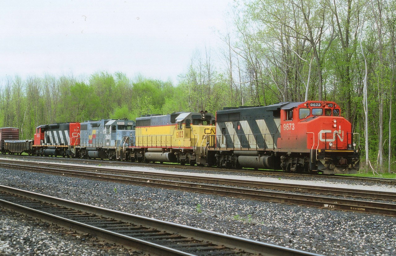 Doesn't it just figure? I drive down to Merritton from north end St. Catharines where I was living at the time and this lashup goes by just as I am approaching. So off to Burlington I go. For this is the closest location in which I can shoot a Toronto-bound train without the morning sun in my face. Fortunately for me it is working Aldershot Yard, so the sluggish traffic on the QEW doesn't cause me to lose this train. Leader CN 9673 was former GO 706. Second is x-UP, now CN 6103, followed by former Seaboard 2601 now sublettered HLLX and CN 5313 trailing. I assume all units have now vanished from the CN roster.