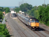VIA F40PH-2D 6417 blasts eastbound through Burlington GO Station on its way to Toronto on a lush, green day. There's no shortage of dead bugs splattered all over 6417's nose, meeting their unfortunate end as the mighty 3000 horsepower beast hustled back and forth across southern Ontario.
<br><br>
While the VIA didn't stop for them, passengers gather on the third track awaiting the arrival of the photographer's former GO train, #907 from Toronto, which will be soon heading back here from Aldershot as #912 (note to viewers, although not condoned, you can beat a GO train from Exhibition Station to Burlington with some time to spare, but only if the weekend traffic on the QEW is good...)
