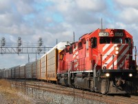 CP 6043 and 6049 leave under threatening skies eastbound from Wolverton yard having collected more autoracks.