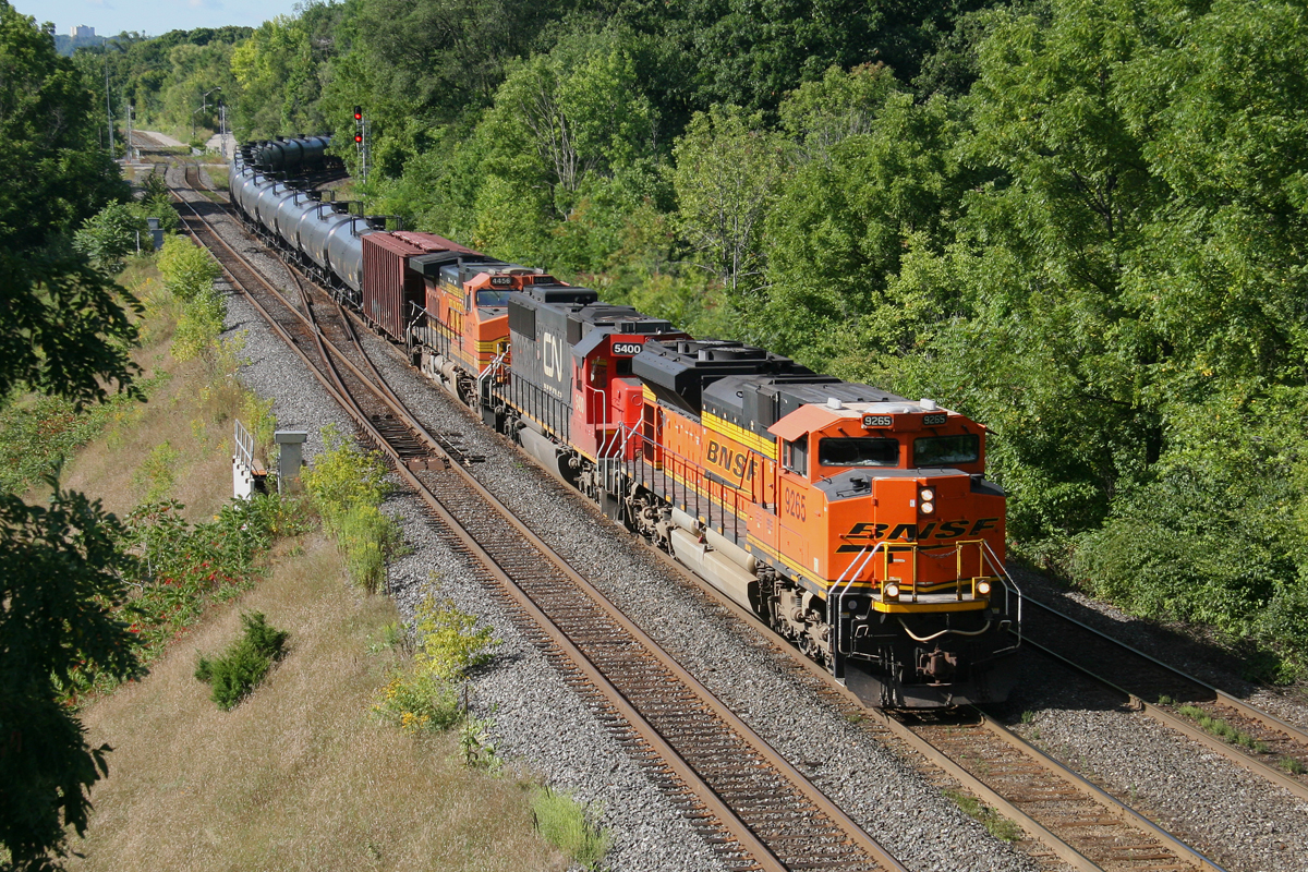 After calling the Rule 42 foreman to clear the tracks at the RBG Laking Garden footbridge, CN U710 exits the Dundas Sub at Bayview onto the Oakville Sub.  A nice treat today, Aug 28, 2014 at 10:21am with BNSF 926, followed by class leader CN 5400, and another BNSF, 4456.