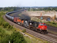 CN 710 rolls through Whitby with 2565, NS 6644 and BNSF 5837 (Thanks for the heads up Gord). In the background, construction crews continue to move land for GO Transit's proposed Whitby Maintenance Facility.