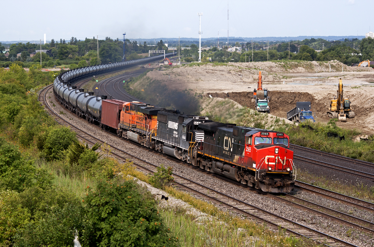 CN 710 rolls through Whitby with 2565, NS 6644 and BNSF 5837 (Thanks for the heads up Gord). In the background, construction crews continue to move land for GO Transit's proposed Whitby Maintenance Facility.