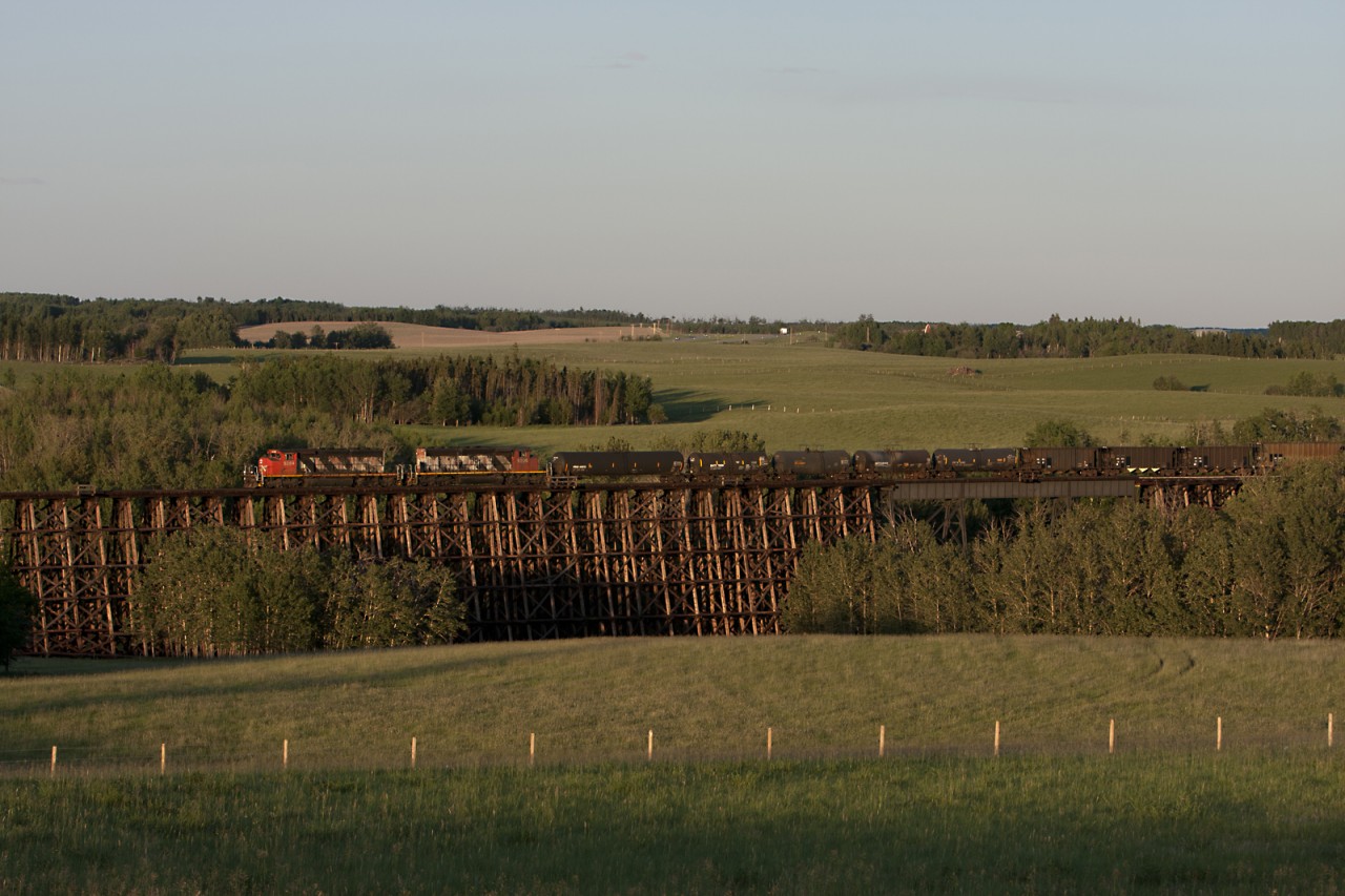 Westbound local crosses the Paddle River Trestle at sunset