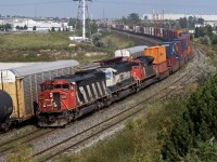 With the AC on full blast, CN 149 finally rolls through Whitby after holding at Oshawa West for a VIA. On the north track is Toronto-Moncton train #308.