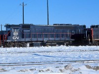 Before GO Transit started up in 1967, the eight unique HEP-equipped GP40TC units GO ordered from GMD London were used in break-in service on CN freights, often times with CN units too. They were painted slightly different than they would look in a year: an all dark blue "stealth" paint version with white CN logos and numbers, no white cab or frame highlights, and no large GO logos on the long hood. Shown here is a rare look at "CN" 601 at Toronto Yard in 1966 (later renamed MacMillan Yard), with another sister GP40TC visible behind SW1200RS 1318.
<br><br>
The units would be touched-up before entering GO service, with white paint applied to the cab, front logo panel and frame, and new GO logos and numbers would be applied. All are still in service with Amtrak as rebuilt GP38H-3's.
