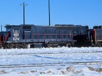 Before GO Transit started up in 1967, the eight unique HEP-equipped GP40TC units GO ordered from GMD London were used in break-in service on CN freights, often times with CN units too. They were painted slightly different than they would look in a year: an all dark blue "stealth" paint version with white CN logos and numbers, no white cab or frame highlights, and no large GO logos on the long hood. Shown here is a rare look at "CN" 601 at Toronto Yard in 1966 (later renamed MacMillan Yard), with another sister GP40TC visible behind SW1200RS 1318.
<br><br>
The units would be touched-up before entering GO service, with white paint applied to the cab, front logo panel and frame, and new GO logos and numbers would be applied. All are still in service with Amtrak as rebuilt GP38H-3's.