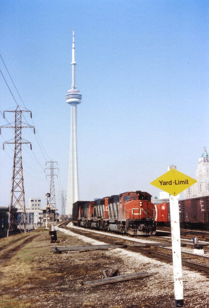 Toronto certainly looked different downtown back in 1977. Where are all the buildings? The CN Tower had just been built and the Royal York Hotel dominated the skyline around Union Station. Here we see eastbound CN 9533, 9448 and 9456 approaching Jarvis Street in an image that would be impossible today. Once accessible to railfans, this location is non-existent now. As far as the CN GP40-2 widecabs are concerned, the lead unit went to Mass Transit Authority by 1997 and the other two dealt off to ALSTOM in 2001.
