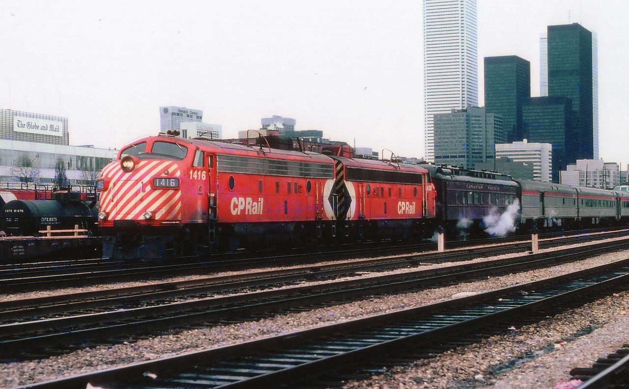 The CP Canadian is shown here leaving Union Station in downtown Toronto for the western run to Vancouver. Back in the days before VIA, we see CP 1416 and 1400 up front. I'm wondering if that heavyweight coach behind the power was on the RCP train to London yesterday? Toronto financial district in the background, and off to the left, the offices of the Globe and Mail newspaper, aka: Mop and Pail. The skyline pales compared to today.