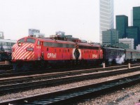 The CP Canadian is shown here leaving Union Station in downtown Toronto for the western run to Vancouver. Back in the days before VIA, we see CP 1416 and 1400 up front. I'm wondering if that heavyweight coach behind the power was on the RCP train to London yesterday? Toronto financial district in the background, and off to the left, the offices of the Globe and Mail newspaper, aka: Mop and Pail. The skyline pales compared to today.