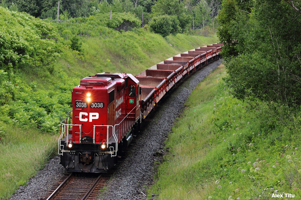 Here's one from not to long ago. On July 29th, 2014, me and my good friends Louisa and Warren made a long awaited trip out east to the Newtonville area. One of the stops Warren suggested for us was Nichols Road. Louisa and I not knowing anything about it, we agreed to head over. I must say I was quite impressed when we arrived. It's certainly a good location.

Now I wouldn't remember the order of the trains we saw that day, but I can tell you we certainly had an abundance of VIA, and a shortage of CP trains to say the least. So much so we were becoming a little frustrated.

Eventually, the scanner crackles to life with some talk of a CP 3038 heading west on the Belleville Subdivision. At first we assumed that it may be the Trenton Turn. Nothing special, right? Well, we were wrong in a very good way. Chugging past the corner comes CP 3038 alright, but look, it's running long hood forward! Not only that but our first assumptions of this being the Trenton Turn are quickly dismissed once we notice the short string of ballast cars in tow. Now I'm not sure how often you see a work train running long hood forward on CP, but it was certainly a welcome surprise.