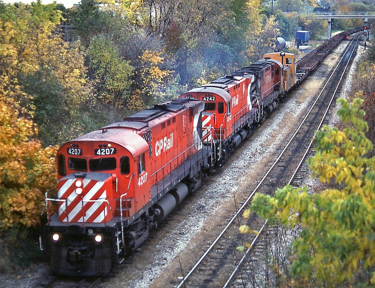 When CP took over running the Steel Train from CN, the power changed from zebra-striped F-units and Geeps to Action Red C424's, SW1200RS, and leased Chessie & B&O power. Here CP C424 4207 leads 4242 and another sister as they head for Nanticoke from Hamilton, running on the former TH&B just before going up the Niagara Escarpment.