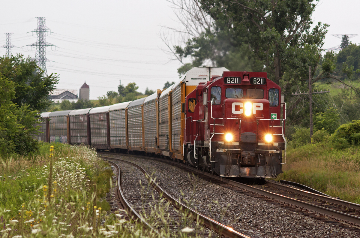 CP 8211 leads a long string of empty autoracks bound for GM in Oshawa.