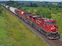 A friendly wave and a toot on the horn from the hogger as 119's train approaches behind one of the Holiday train units, CP 9815, leading 9641 and 9157 at Newtonville, Ontario. The SD90 was coming back dead from the NS, having been repaying HP hours owed, made it's way to Winnipeg for repair, and then went back to the NS for further abuse. 1739hrs.