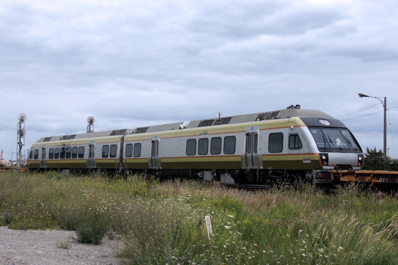 Early Thursday it had been confirmed that the first of the Nippon-Sharyo Diesel Multiple Units for the Union Pearson Express were on their way to Toronto. With this equipment poised to make significant impact on passenger rail in the Greater Toronto Area, it was only fitting to attempt to see them as they first arrived, despite the less than favourable photography weather and threatening clouds. I am surprised that I was not caught outside in the rain!

Before this train approached the Brampton Intermodal Terminal, a new 148 called himself out to head east, interestingly also symboled Q14891 13, leading to an interesting discussion between the crew and RTC. The RTC explained that since the trains were operating with identical symbols, they could not both be on the main track at the same time. The new 148 would not be able to leave until after the original 148 had entered the BIT. After making great time over the Dundas and Halton Subs, just 25 minutes from Mansewood to Torbram, this monster of a train ground to a crawl to enter the BIT. Those in the queues on Torbram Road not too impatient to watch the train slowly rumble by were rewarded with the sight of the new DMUs a whopping 29 minutes after the automatic warning devices were first activated. The delay was so lengthy that there was even an accumulation of pedestrian traffic - a rarity in the industrial jungle of the area - and a few of the pedestrians pulled out smartphones at the sight of the DMUs. I haven't found any of their photos on Twitter or Instagram, but the posts are likely to start popping up once the public becomes aware of the arrival.
