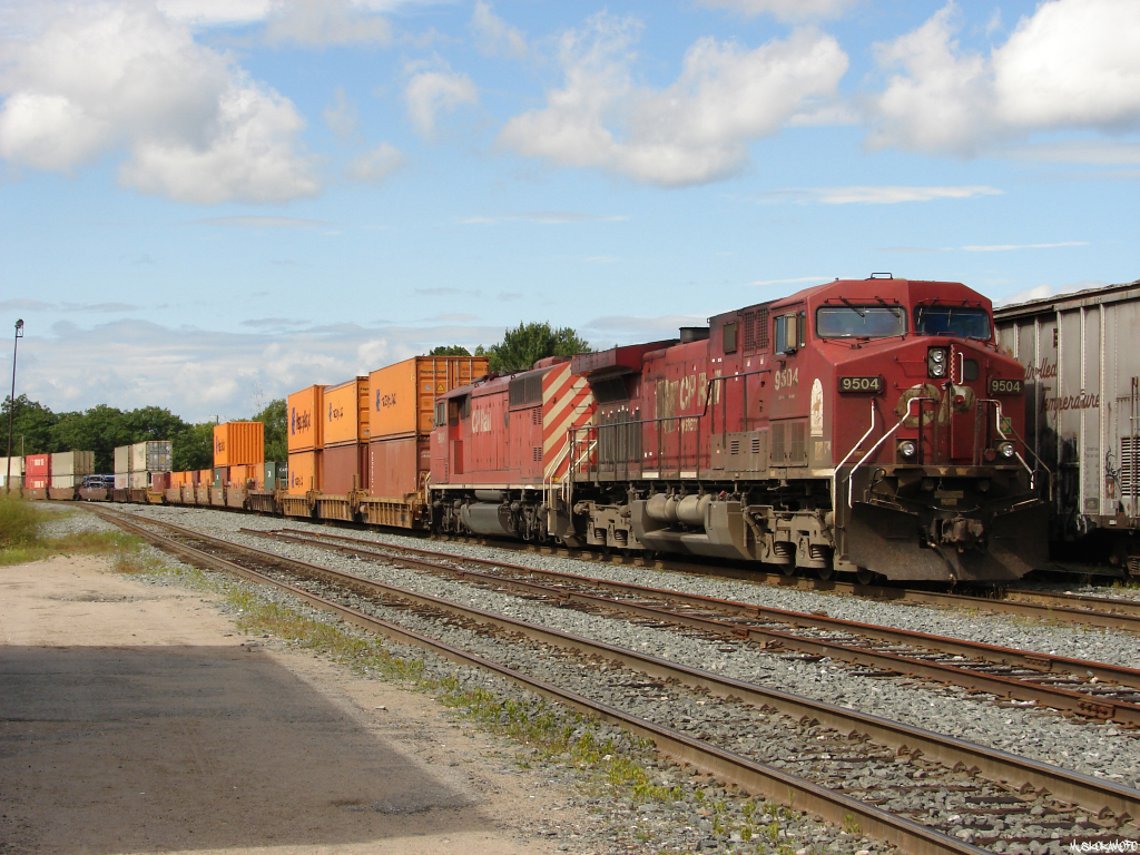 CP 9504 South tied down in what used to be known as track 2 infront of Station Name Sign MacTier, but as you can see since the Maple Street cut-over track 1 just kind of ends! 118 would stage here to let business move 40B-13 by on the main without interruption, trailing SD40-2F 9004 seems to be in much better shape than newer AC4400CW 9504!