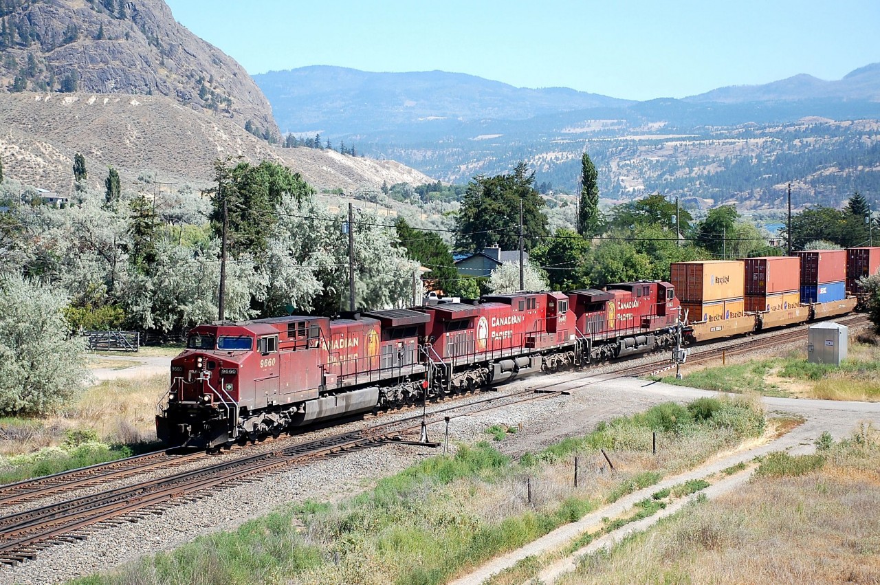 Three "beavers" led by CP 9660 are cruising westwards through Monte Creek with a load of containers.