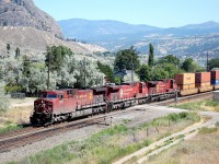 Three "beavers" led by CP 9660 are cruising westwards through Monte Creek with a load of containers.