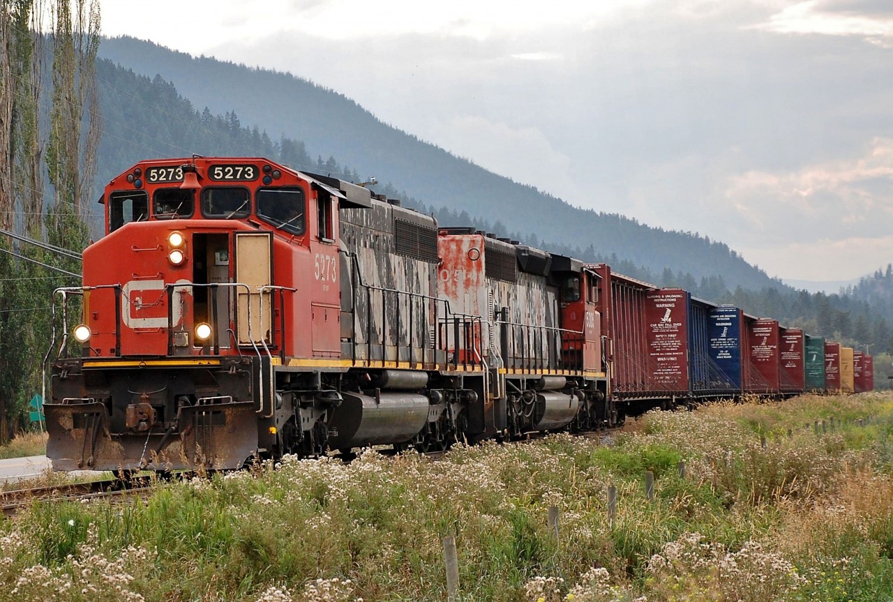 CN nos.5273 & 5305 are approaching Lavington on the Lumby sub with a load of empty centre beams.